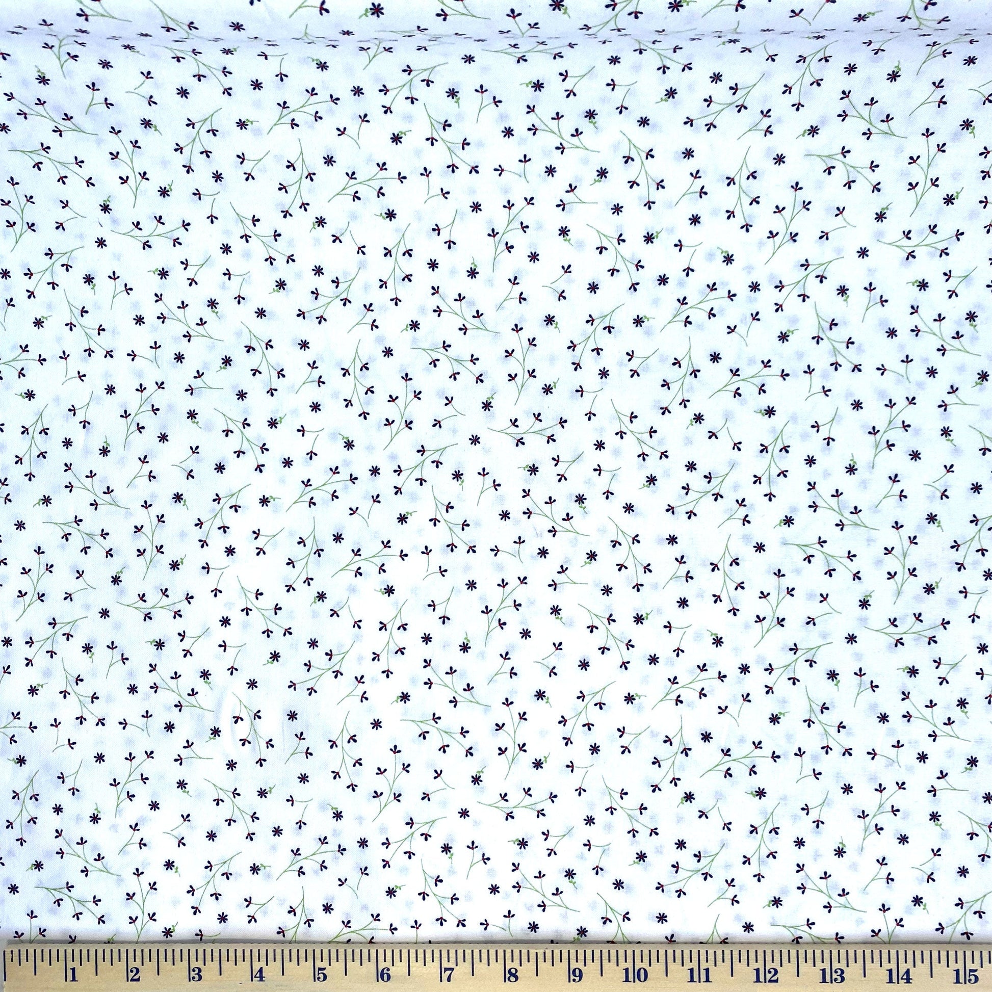 The mini navy flowers are placed on a white background and are a compliment to the summer-time theme of Red, White & Bloom by Kim Christopherson of Kimberbell for Maywood Studio. Although a coordinate of the original line, this fabric is a great alternative to a solid or tone on tone fabric when a white background color is needed. Stitcher's Joy